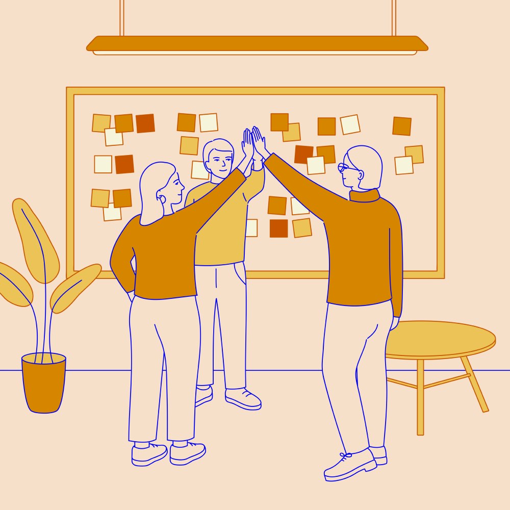 Co-workers doing a high-five after a planning meeting
