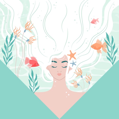 Dreamy woman with fish and seaweed floating through her hair