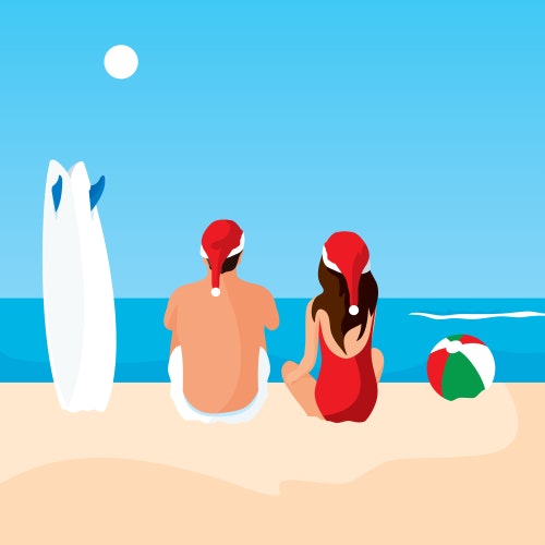 Surfers wearing Santa hats at the beach on a sunny day