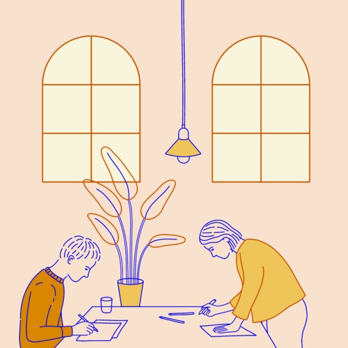 Two artists working at a shared desk