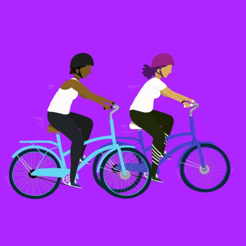 Two people riding bicycles together