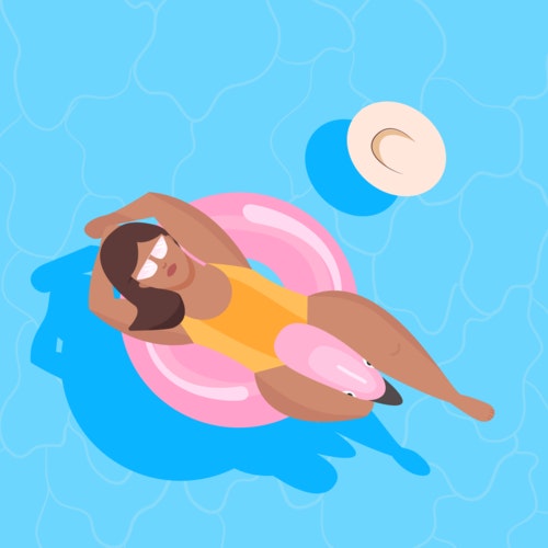 Woman relaxing in a pink flamingo pool float