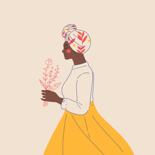 Woman wearing a bright headscarf and carrying flowers