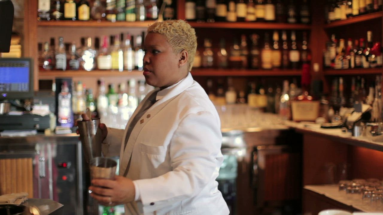 A bartender preparin judi bola 888 g a pink cocktail