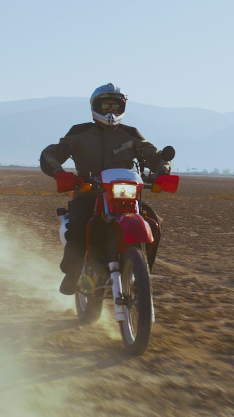 A biker riding through the desert