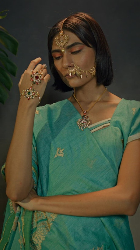 A captivating woman in traditional Indian attire strike a pose.