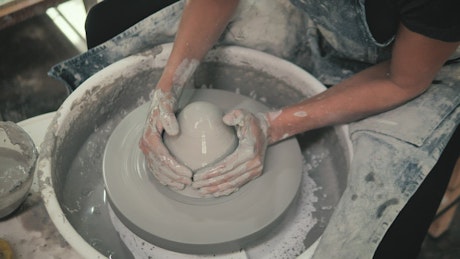 A ceramic artist modeling pottery