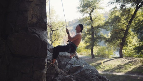 A climber testing the ropes on the rock