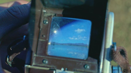 A close-up shot of an old photography camera viewfinder.