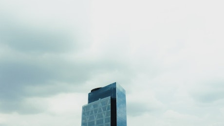 A corporate building on a cloudy day