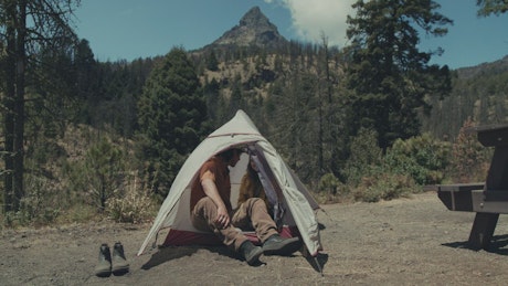 A couple talking in a tent
