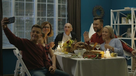 A family taking a selfie on Thanksgiving dinner.