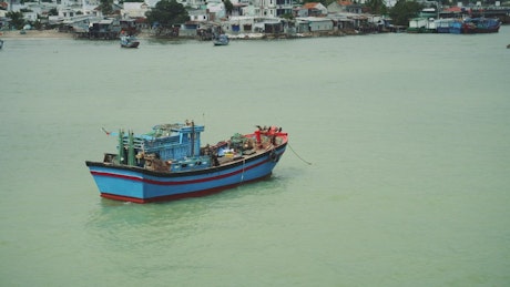 A fishing boat docked near a harbour town in Vietnam.