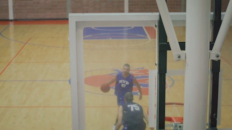 A game of one on one basketball between two players.