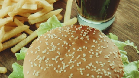 A hamburger and french fries close up.