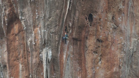 A man climbing a cliff