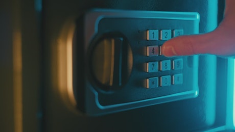 A man dialing a secret code to open a vault.