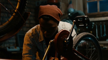 A man fixing a bag in the garage.