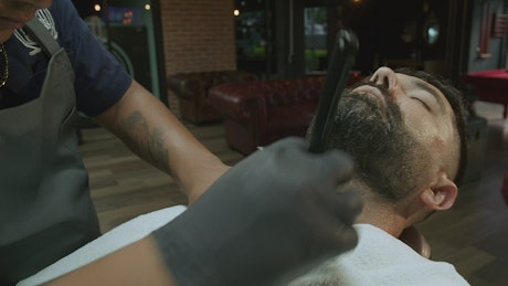 A man getting a beard trim.