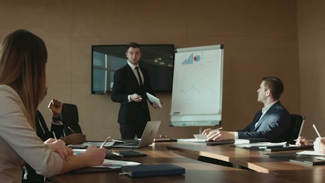 A man is presenting a business report