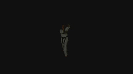 A man practice karate moves over a black background.