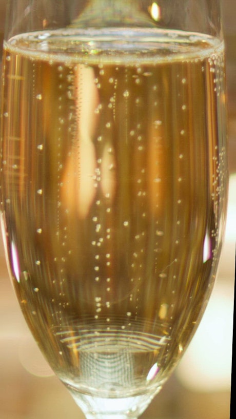 A mesmerizing golden bubbly drink close-up.