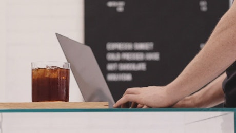 A person working while drinking coffee