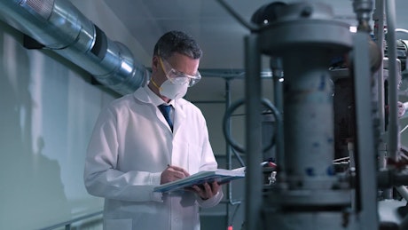 A scientist with a face mask on the laboratory