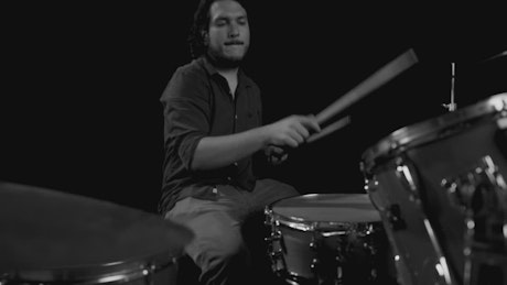 A talented drummer in black and white.