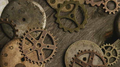 A variety of clock gears on a table.