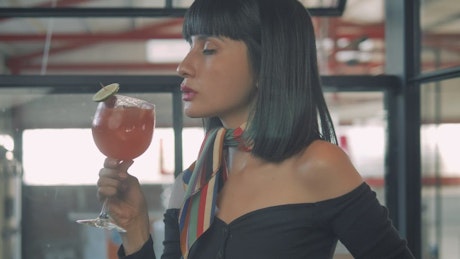 A woman enjoying a cocktail.