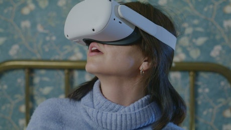 A woman wearing virtual reality glasses.