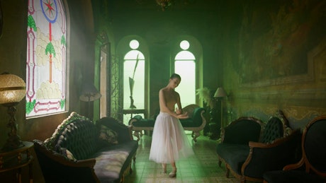 A young ballerina performing spins in a vintage living room.