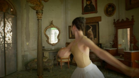 A young ballerina performs classic ballet spins in a vintage decorated bedroom.