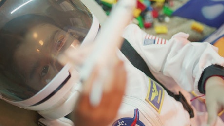 A young girl pretending to be an astronaut.