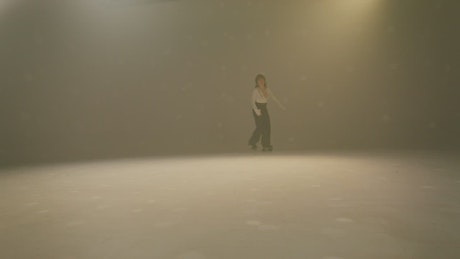 A young woman skating toward the camera.