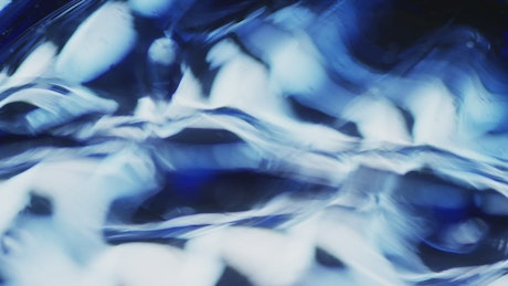 Abstract bluish shapes in motion.