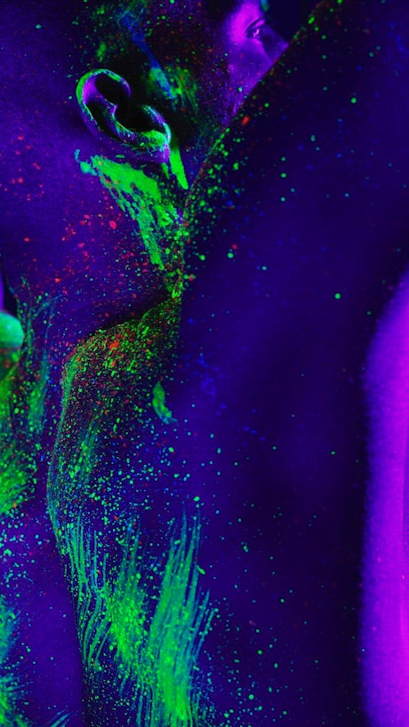 Abstract image of a man stained with phosphorescent paint.