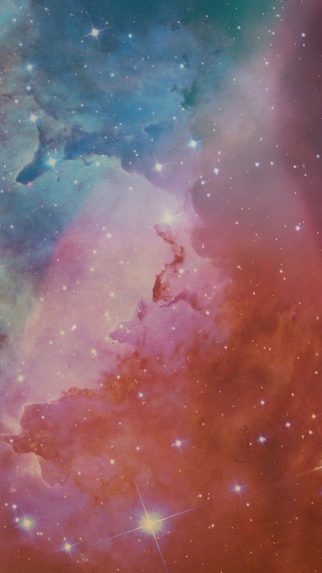 Abstract video of space covered by a nebula and stars.