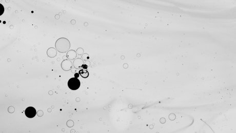 Abstract video thick liquid drops of dark ink.