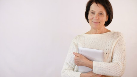 Adult woman smiling with a tablet