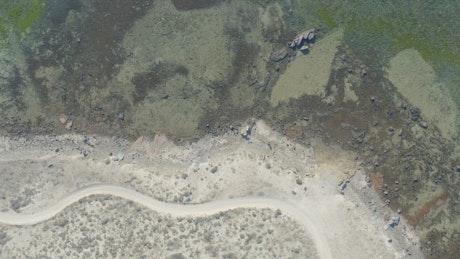 Aerial aerial shot that runs along a sunny coast.