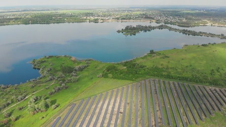 Aerial shot of a field of solar panels in a farm.