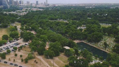 Aerial shot of a park around a river.