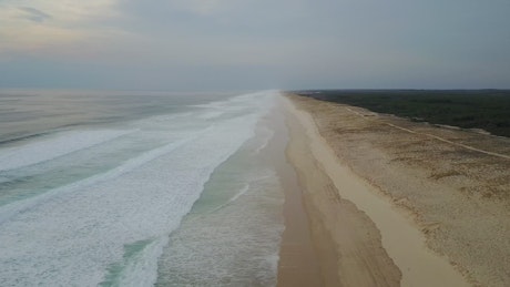 Aerial shot over a sandy coastline.