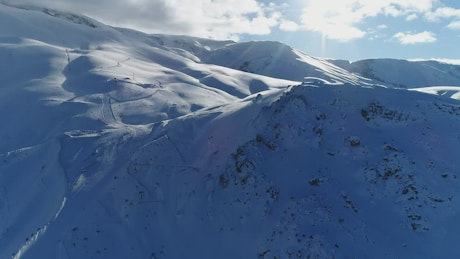 Aerial tour of a snow-covered mountain range.