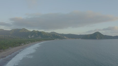 Aerial view of a beach with mountains.