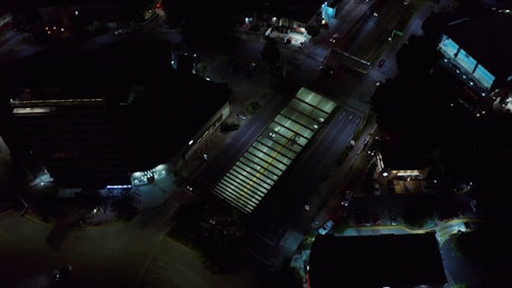 Aerial view of a city underpass with bustling traffic at night.