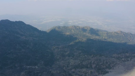 Aerial view of a forest covered by shadow.