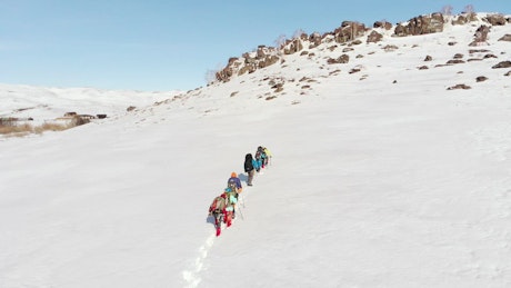 Aerial view of a group of experienced mountaineers hiking.